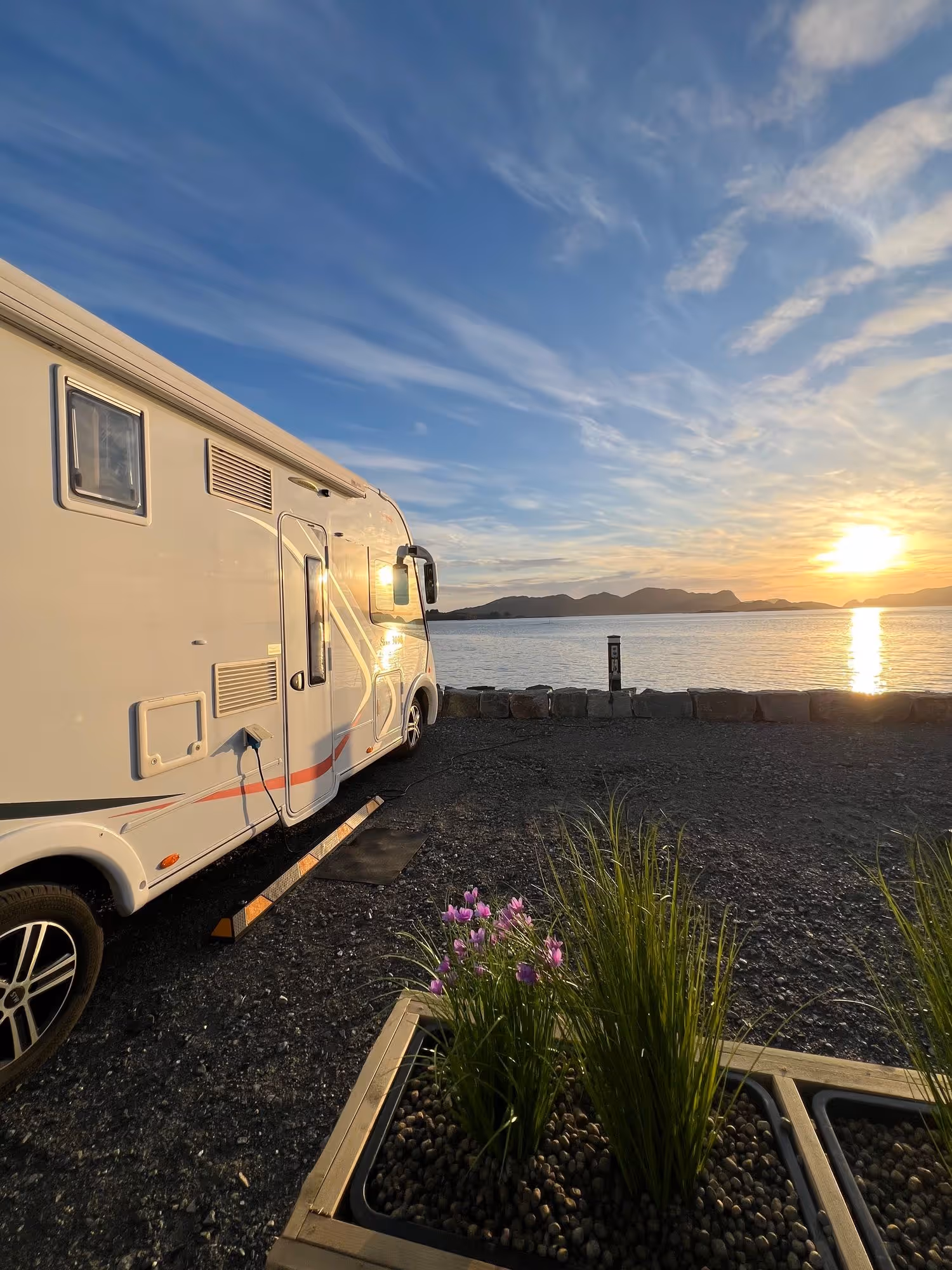 Bobil ved havet i varm kveldssol